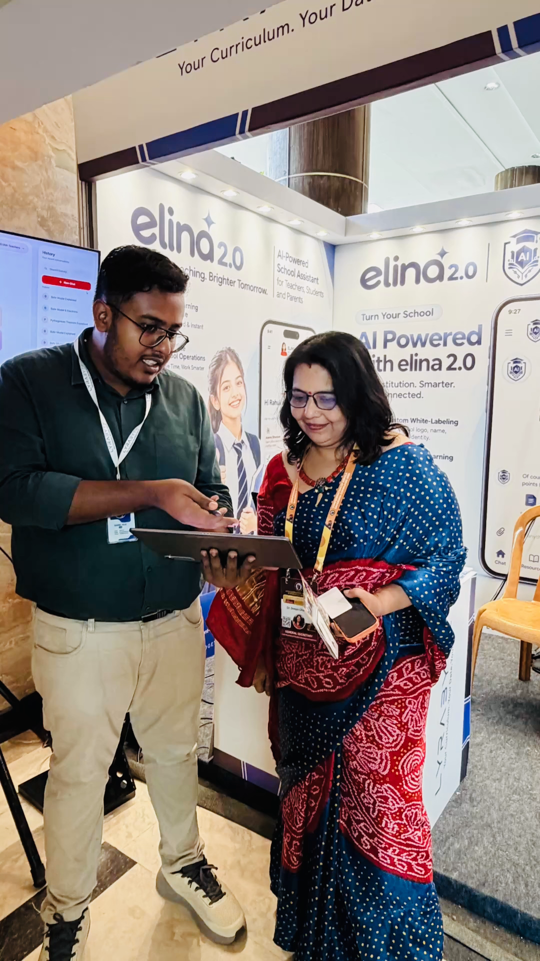 A visitor speaking with the Lyrabyte team at the conference