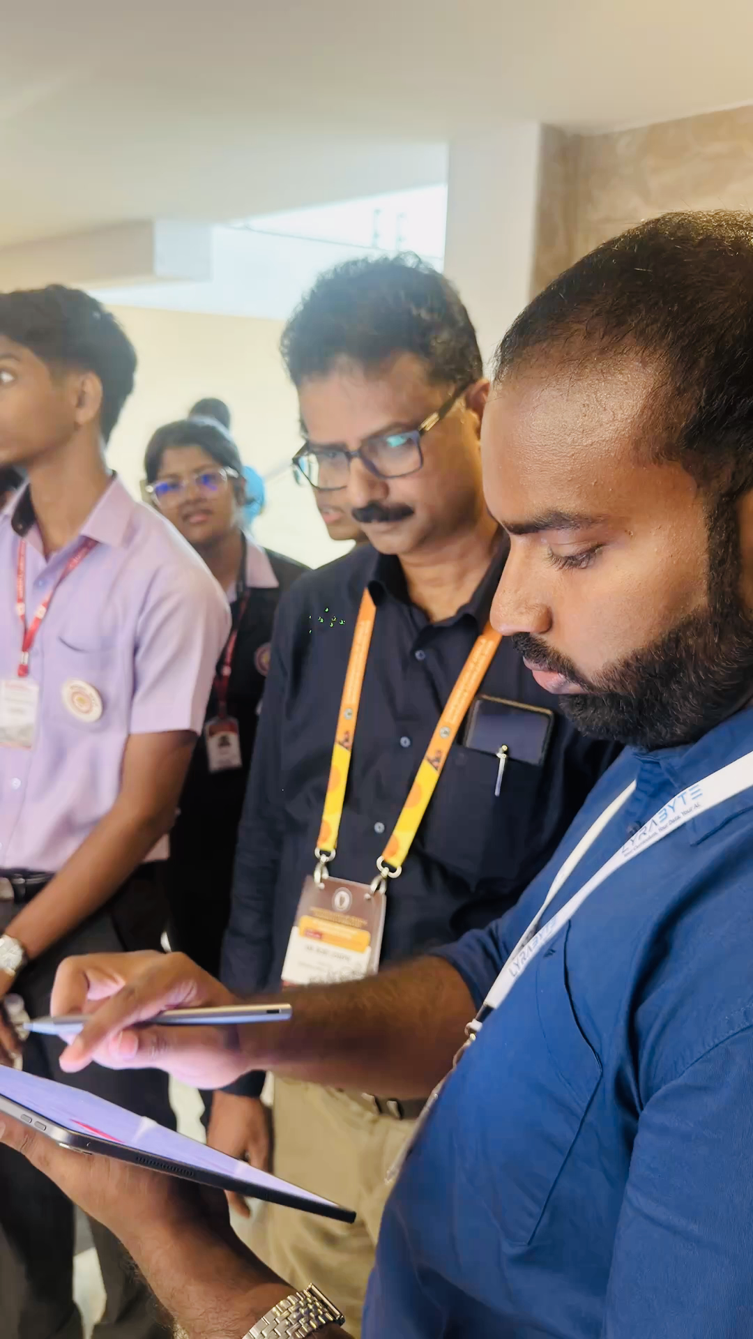 Visitors exploring a Lyrabyte demonstration on a tablet